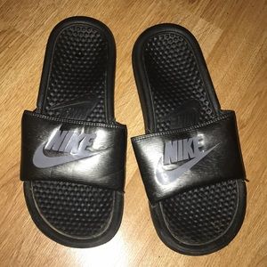 Silver and black nike slides